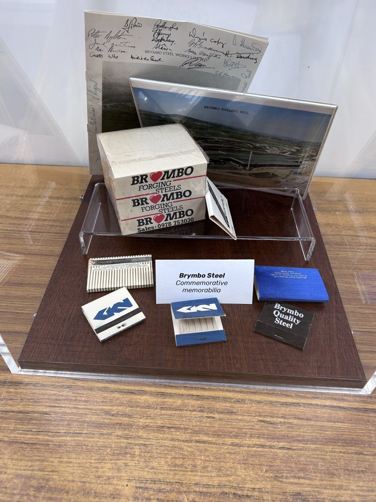 Matchbooks, a block of paper, a brochure covered with signatures, and a photograph wrapped in plastic.