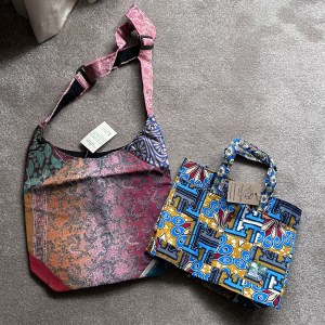 A shoulder bag with a sari pattern on the left and a tote bag with an African pattern on the right.